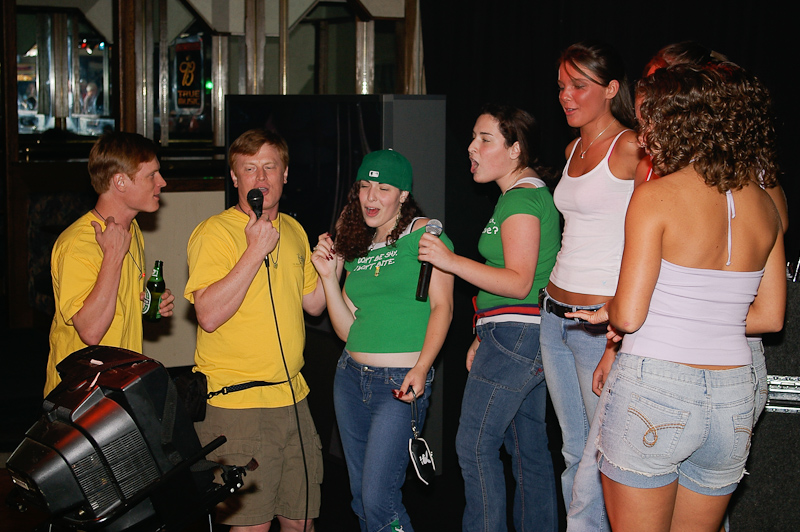 August 04, 2005@22:40<br/>Neal and Nelson help along the new kids from L.A. (Rachel and Lauren - in the green) in a group Karaoke session
