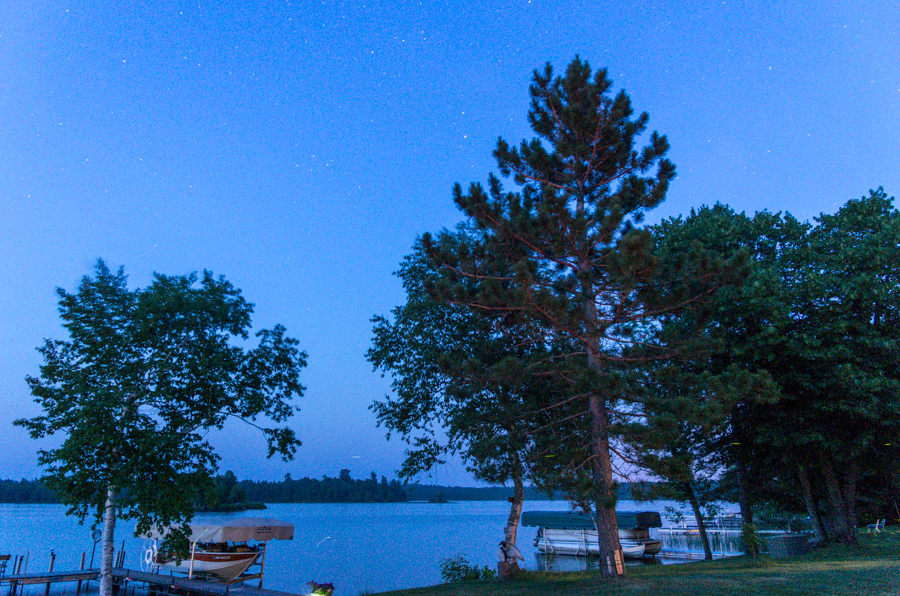 Trying to catch fireflies with the camera - caught a couple in this 30-second exposure (look to the right of the boat).  And stars!<br />July 11, 2013@22:27