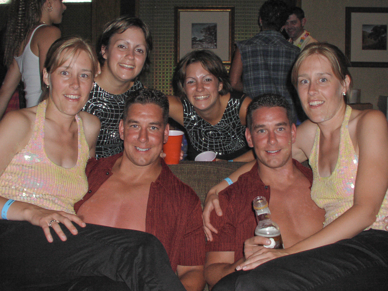 August 03, 2003@01:20<br/>This is Nick and Jim Falco, from Chicago, sitting on the couch. On their laps are Kathy and Stefanie, from (mumble mumble) Bay, Canada. (I'll get that location fixed as soon as I can see John's copy of their business card!). Behind the couch are two as-yet-unnamed Canadians. Sorry for the lack of detail on this one....