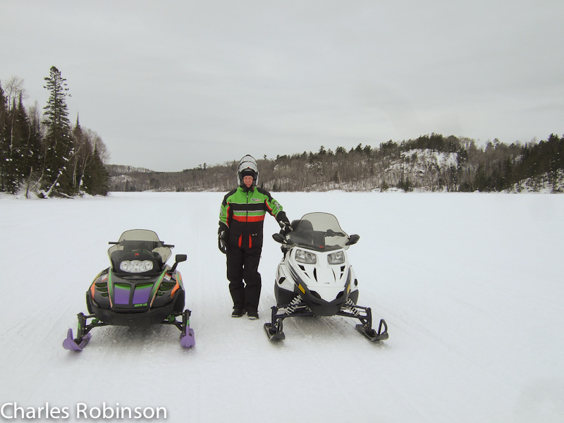 February 12, 2011@11:18<br/>Steve by our rides..  Somewhere between Lake Vermilion and Burntside Lake.  On our way to Ely!