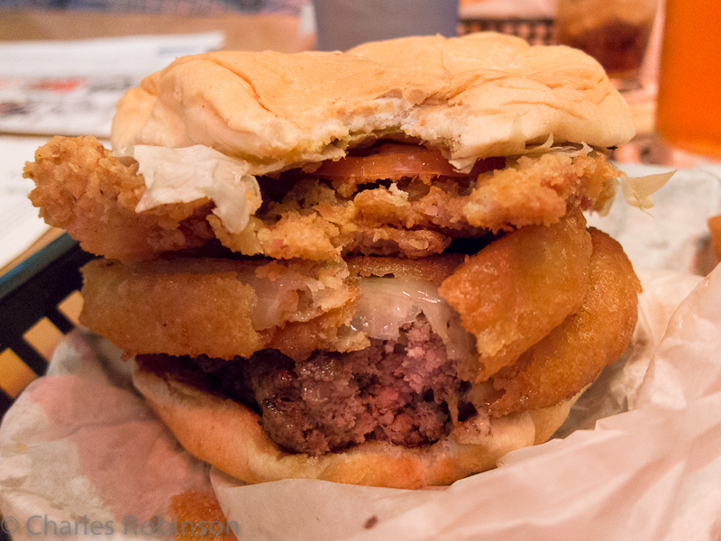 Some kinda unholy burger at a sports bar in Houston - burger, onion rings, tomatoes, and deep-fried bacon.  Oh - and lettuce, but who cares?<br />March 22, 2012@19:41