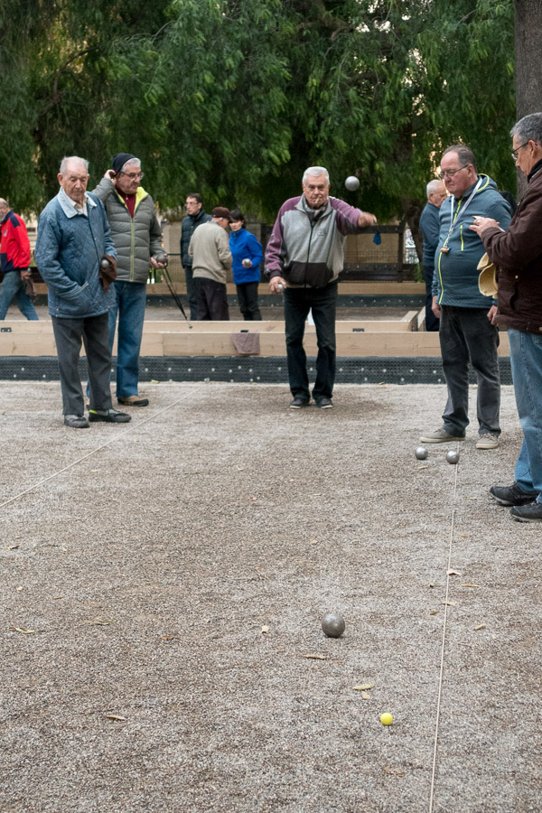 Men playing Petanque in the park.