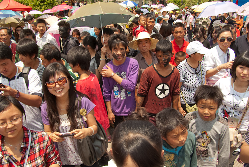 May 01, 2010@13:35<br/>At Sun Square at the end of the parade there was a face-blackening game.  It's good luck 