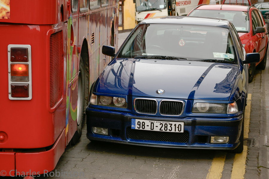 ..and just narrowly missing this BMW. Only took her about 5 minutes to make the turn.  Note that the BMW is in a no-parking zone (the double-yellow against the curb).<br />June 17, 2005@13:02