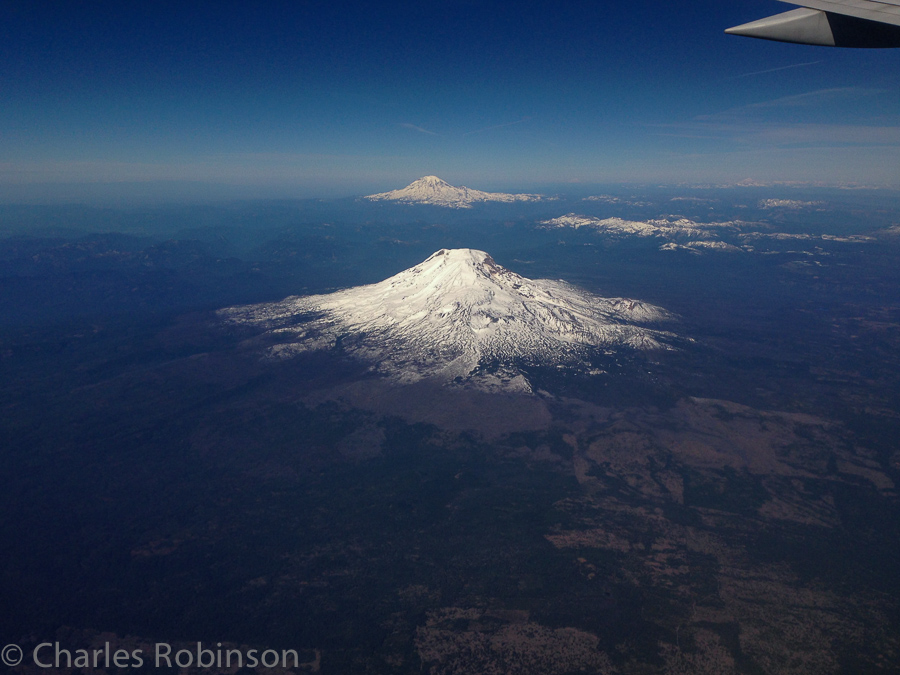 Mountains Adams and Rainier, as we head home.  About 10 and 50 miles away, respectively.  As I was taking this image, the woman in the seat in front of me had taken a similar photo and was in the process of sending it from her phone.  Yup, while we were flying.  I saw the 