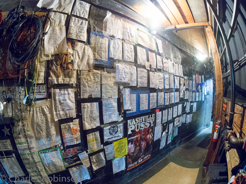 Behind the stage is a collection of setlists from past shows.  Many of them are autographed.  I love this wall!<br />June 10, 2016@17:46
