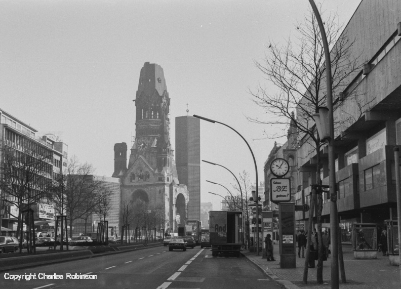 Kaiser Wilhelm memorial church, West Berlin. It was left in ruins as a reminder of the war. The hexagonal tower behind it is a new belfry completed in the 1960s. raw0009.jpg